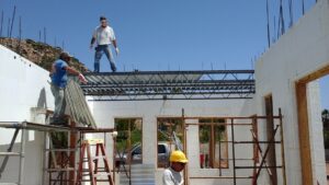 Worker on a composite concrete roof deck over ICF walls