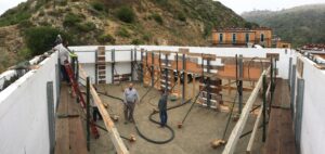 Crew pumping concrete into braced ICF walls at Canyon Acres