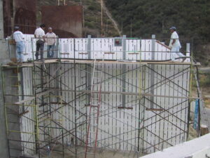 Crew atop tall ICF walls at the Carol Residence