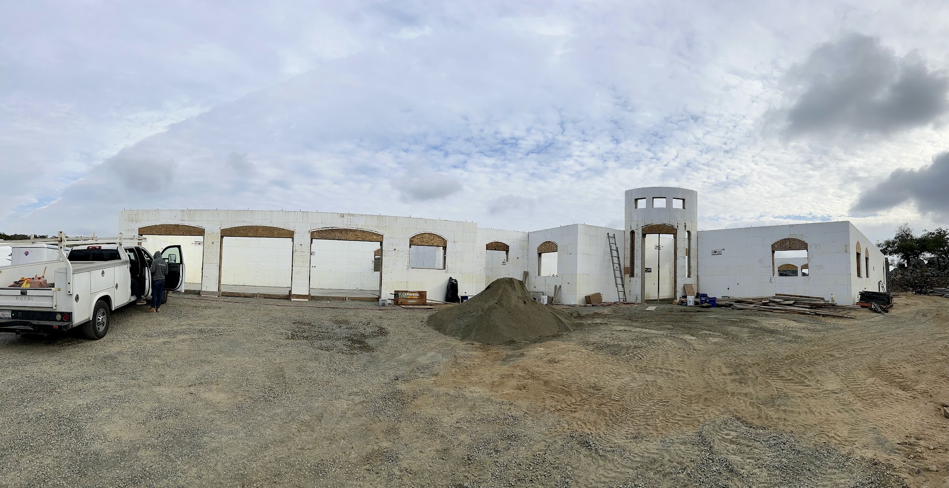 Full ICF shell of the Koll custom home with arched openings and round entry tower
